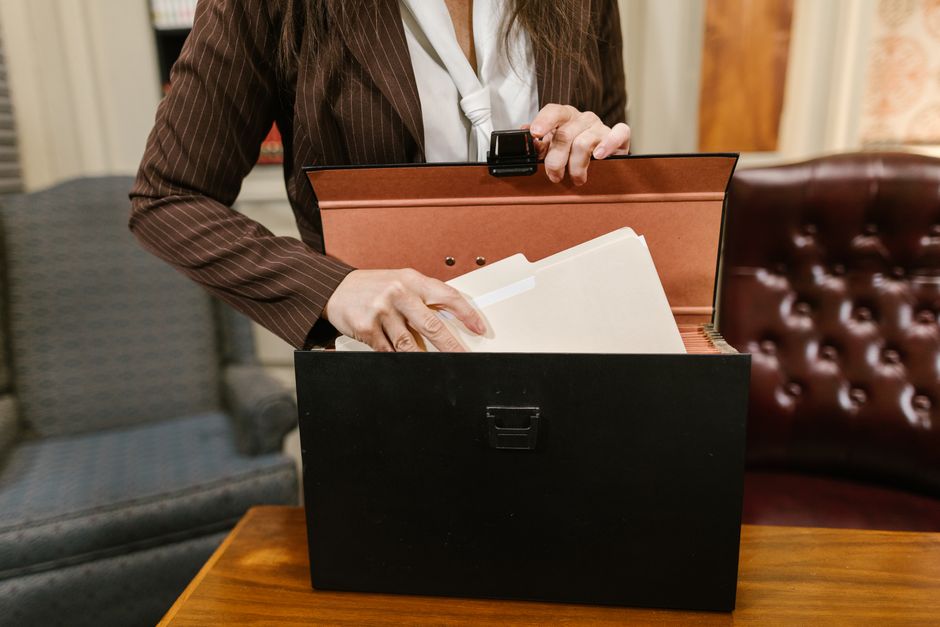 Profissional do direito conferindo petição inicial em mesa de trabalho organizada